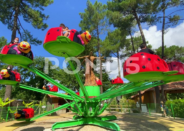 La Coccinelle Ladybug-shaped merry-go-round in La Cocc... | Stock Video | Pond5 photo