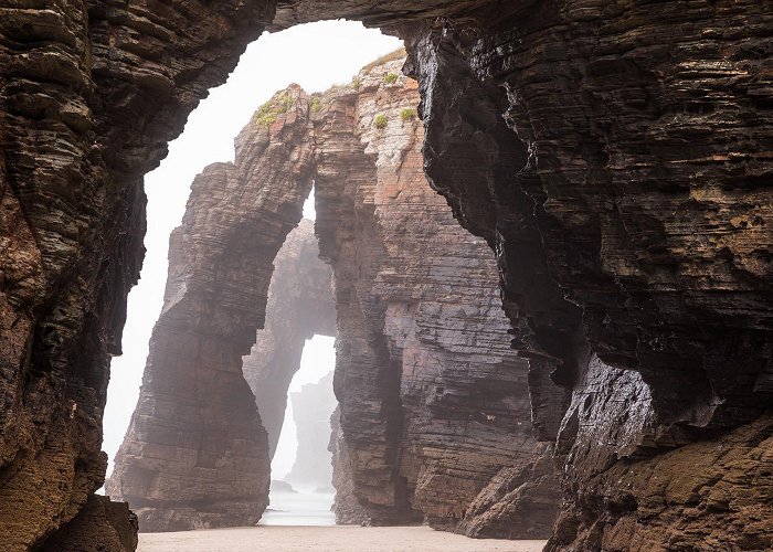 As Catedrais Beach Natural rock arches on Cathedrals beach in low tide, Praia As ... photo